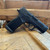 Sig Sauer P365 XMacro TACOPS 9mm pistol with 3.7 inch barrel, optics ready slide, XRAY3 night sights, and black finish angled downward to the right, in store image