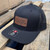 Ready Gunner black trucker hat with leather logo patch and adjustable snapback closure