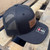 Ready Gunner black trucker hat with leather logo patch and adjustable snapback closure other side view