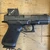 Glock 19 Gen 6 COA 9mm pistol with factory installed Aimpoint COA red dot optic pointing to the right, in store image