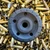 Stealth Additive Works Tisha 5.56 Inconel suppressor with HUB compatibility and black Cerakote finish on empty ammo casings, in store image, tip