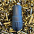 Stealth Additive Works Tisha 5.56 Inconel suppressor with HUB compatibility and black Cerakote finish on empty ammo casings, in store image
