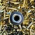 Stealth Additive Works SHIV 9mm titanium suppressor with direct thread mounting and lightweight 3D printed construction on empty ammo casings end side, in store image