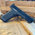 Ruger RXM full size 9mm pistol with Magpul gray frame, optics-ready slide, and tritium front sight, in store image angled downward