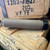 HUXWRX FLOW Range 36 Ti titanium suppressor in flat dark earth with Flow-Through technology and HUB compatible mounting system, in store image on its side