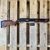 Mossberg 590S Shockwave 12 gauge pump action firearm featuring WOOX Gladiatore American walnut grip and M-LOK forend upgrade, matte blue finish, 14.375-inch barrel, and compact defensive configuration, in store image, pointing to the right