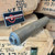 StingerWorx EVO Ti .308 suppressor in Flat Dark Earth featuring full titanium construction, HUB-compatible mounting system, 3D-printed monolithic core, and hard-use rifle suppressor design, in store image angled thread view