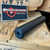HUXWRX Flow 22 Ti .22 LR suppressor with Grade 5 titanium construction, Cerakote black finish, Flow-Through technology, and 1/2x28 direct thread mounting, in store image angled side view