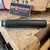 HUXWRX Flow 22 Ti .22 LR suppressor with Grade 5 titanium construction, Cerakote black finish, Flow-Through technology, and 1/2x28 direct thread mounting, in store image side view