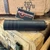 Otter Creek Labs Polonium 5.56 NATO suppressor with Cerakote black finish, 17-4 stainless steel construction, HUB-compatible mounting system, full-size 5.8-inch design, and duty-rated performance, in store image side angle