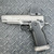 Vudoo Gun Works Priest DS double-stack 1911 pistol in Tungsten Grey featuring an RMR optic cut, flush-cut bull barrel, Red Dirt trigger, Vudoo Tactical Magwell, and aggressive aluminum grip, in store image left