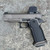 Vudoo Gun Works Priest DS double-stack 1911 pistol in Tungsten Grey featuring an RMR optic cut, flush-cut bull barrel, Red Dirt trigger, Vudoo Tactical Magwell, and aggressive aluminum grip, in store image left