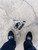 Agency Arms Modified Glock 45 Gen5 9mm Urban Arctic Camo pistol downward view with magazine with shoes of person taking the photo
