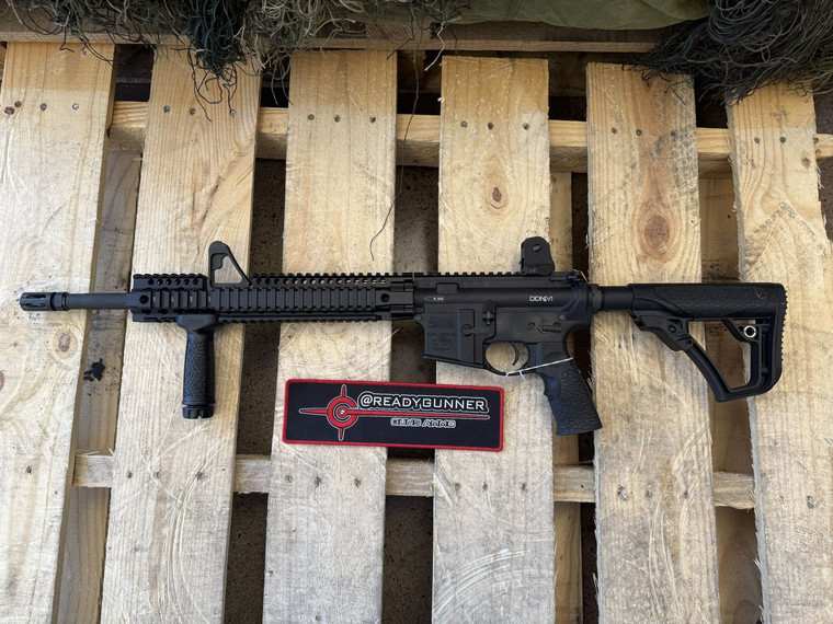 Daniel Defense DDM4 V1 AR-15 rifle chambered in 5.56 NATO with 16 inch cold hammer forged barrel and quad rail handguard pointing to the left