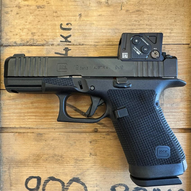 Glock 19 Gen 6 COA 9mm pistol with factory installed Aimpoint COA red dot optic pointing to the left, in store image