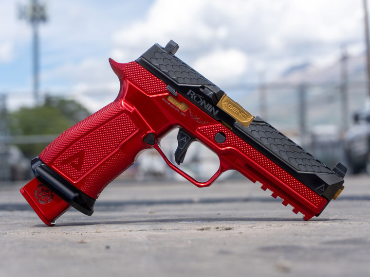 Agency Arms x Ronin Tactics SIG P320 9mm pistol featuring Dragon Scale slide serrations, Agency Optic System, Icarus Precision billet grip module, match-grade barrel, and suppressor-height sights, in store image