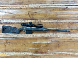 Gunwerks Magnus .300 Win Mag Rifle System with 24-inch barrel, Kahles K525i SKMR4 5-25x56mm first focal plane scope, and Carbon Blue carbon fiber stock, featuring a stainless steel GLR SS action, directional muzzle brake, and GW floorplate, designed for long-range hunting, precision shooting, and tactical applications. Gunwerks Magnus .300 Win Mag Rifle System with 24-inch barrel, Kahles K525i SKMR4 5-25x56mm first focal plane scope, and Carbon Blue carbon fiber stock, featuring a stainless steel GLR SS action, directional muzzle brake, and GW floorplate, designed for long-range hunting, precision shooting, and tactical applications.