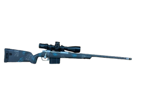 Gunwerks Magnus .300 Win Mag Rifle System with 24-inch barrel, Kahles K525i SKMR4 5-25x56mm first focal plane scope, and Carbon Blue carbon fiber stock, featuring a stainless steel GLR SS action, directional muzzle brake, and GW floorplate, designed for long-range hunting, precision shooting, and tactical applications.