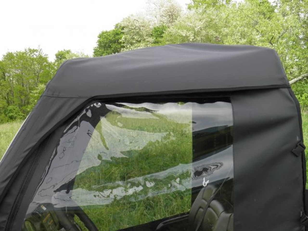 Cab enclosure with vinyl windshield side window view