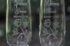 Closeup of Crystal Champage Flutes for the Bride and Groom with Rose and Lily Art by Design Imagery Engraving