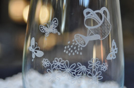 Closeup of Watering Can and Butterflies Wine Glass