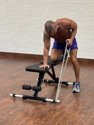 Man Doing Wings exercise with intense resistance band holding intense resistance bands handle grips on intense band adjustable exercise bench
