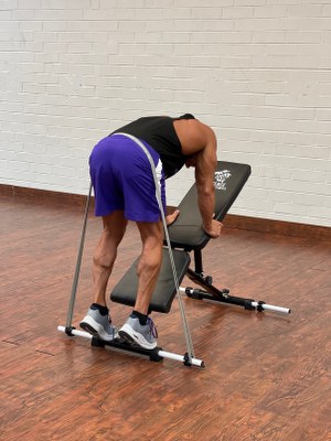 Man Doing legs exercise with intense resistance band  on intense band adjustable exercise bench