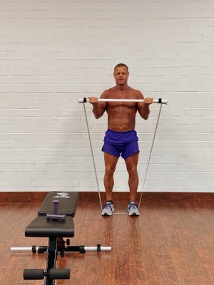 Man doing arm exercise with intense resistance bands 