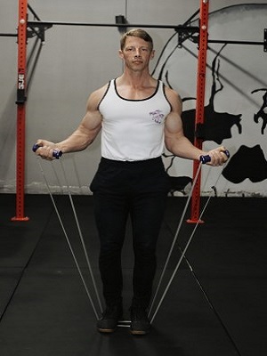 Man Stretching intense resistance bands holding intense resistance bands handle grips  in gym  