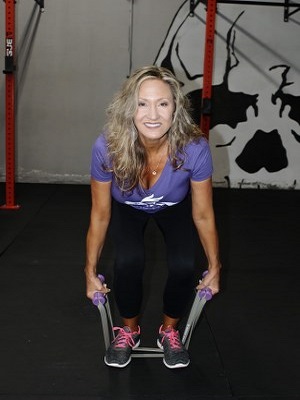 women stretching intense resistance bands holding intense resistance bands handle grips in hands 
