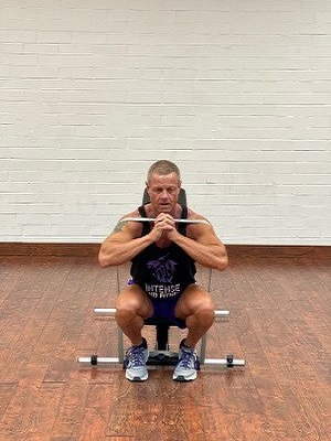 Man Doing legs exercise with intense resistance band at adjustable exercise bench 