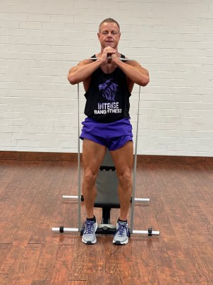 Man Doing legs exercise with intense resistance band at adjustable exercise bench 