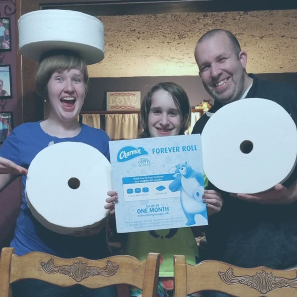 Family with 3 Charmin Forever Rolls