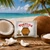 Tortuga Coconut Snack Rum Cake displayed with fresh coconuts.