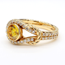Discover unparalleled elegance with this handcrafted masterpiece from Renaissance Diamonds. Made in the USA, this exquisite 14kt yellow gold ring features a stunning 1.15 ct vivid yellow Round 80’s Cut lab-grown diamond as its centerpiece. Surrounded by 0.34 ct of brilliant lab-grown diamond accents in a delicate halo, the design radiates sophistication and charm. The intricately detailed rope-inspired band adds a touch of texture and timeless appeal. Every element of this ring reflects Renaissance Diamonds’ dedication to sustainable luxury and expert craftsmanship.