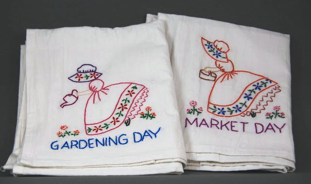 Aunt Martha’s #3553 Colonial Girl Days of the Week iron-on embroidery transfer pattern featuring seven vintage colonial girl designs for tea towels and kitchen décor.