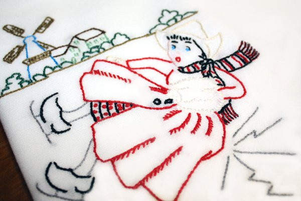 Aunt Martha’s #3597 Dutch Girl Days of the Week iron-on embroidery transfer pattern with vintage tea towel designs.