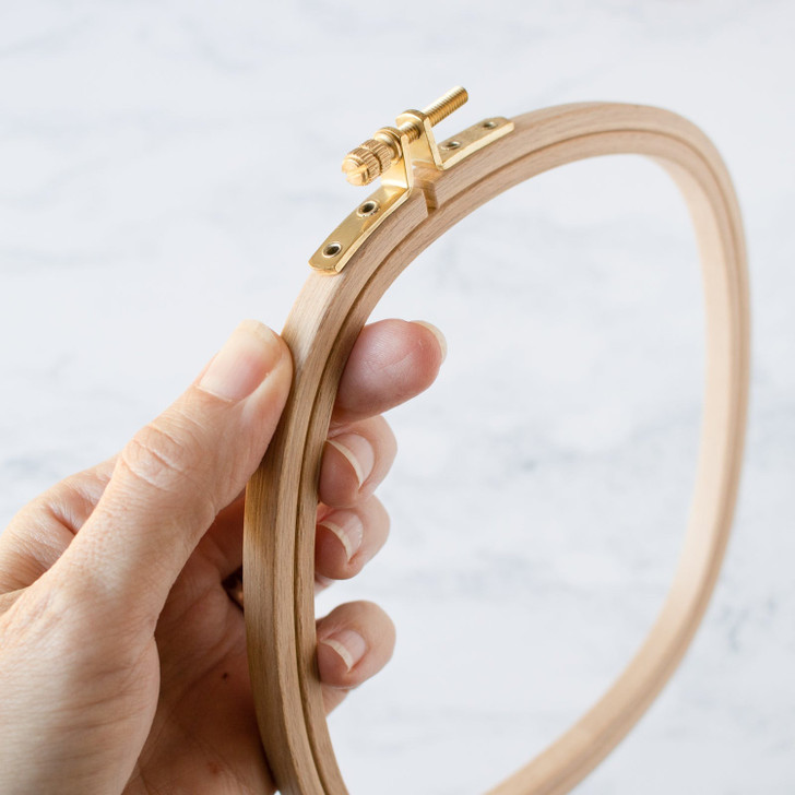 Close-up of DMC square wooden embroidery hoop with smooth finish and secure clasp.