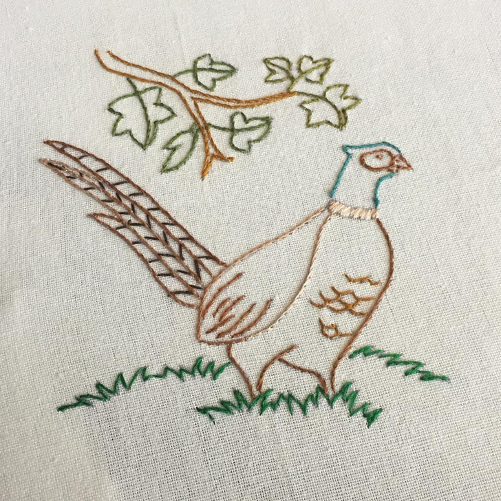 Stitcher’s Revolution® Northwoods Lodge iron-on embroidery transfer pattern featuring cabin, wildlife, and camping scenes (SKU SR46)