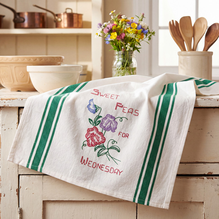 Vogart #215 A Flower A Day for Your Kitchen vintage iron-on Days of the Week embroidery transfer pattern featuring seven floral designs and smaller motifs for potholders and guest towels.