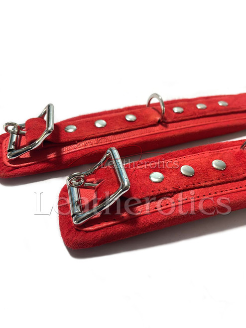 Pair of red suede leather cuffs, top view
