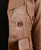 Side profile of brown leather cropped jacket showing tailored fit
