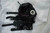 Black leather BDSM hood with open mouth ring and removable buckle straps, flat lay