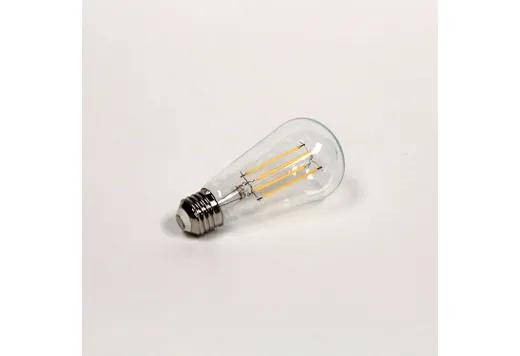 Halco LED S19 Shape Filament Bulb Clear Medium (E26) Base 120V 800 Lumen 15000 hours 80 CRI Dimmable, clear LED filament light bulb on white background.