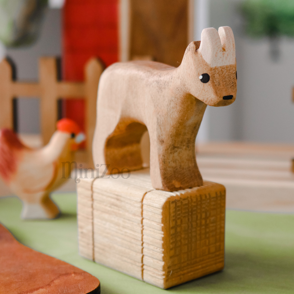 NOM Handcrafted wooden Goat toy on hay stack MiniZoo