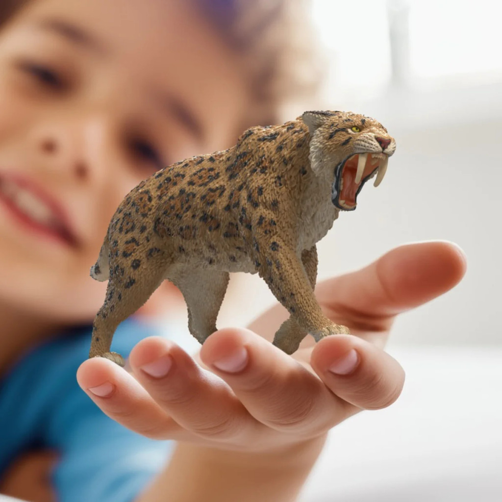 Schleich Smilodon toy lifestyle size in hand