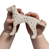NOM Handcrafted wooden Dalmatian toy in hands