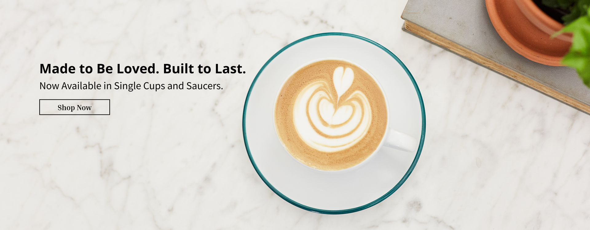 Teal rimmed Verona cup with a latte art heart.