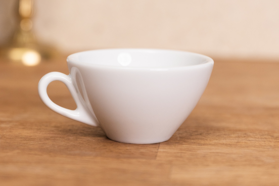 An Ancona Cappuccino mug sitting on a countertop.