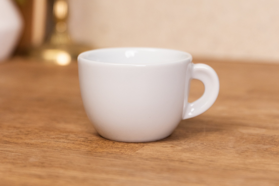 An Edex Cappuccino mug sitting on a countertop.